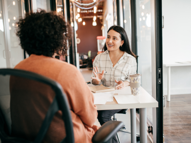 Recruiter and Candidate Sitting At A Desk